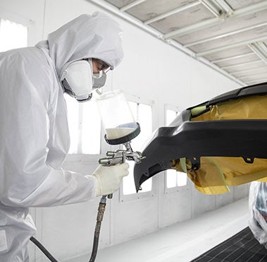 Collision Center Technician Painting a Vehicle | Space City Toyota in Humble TX